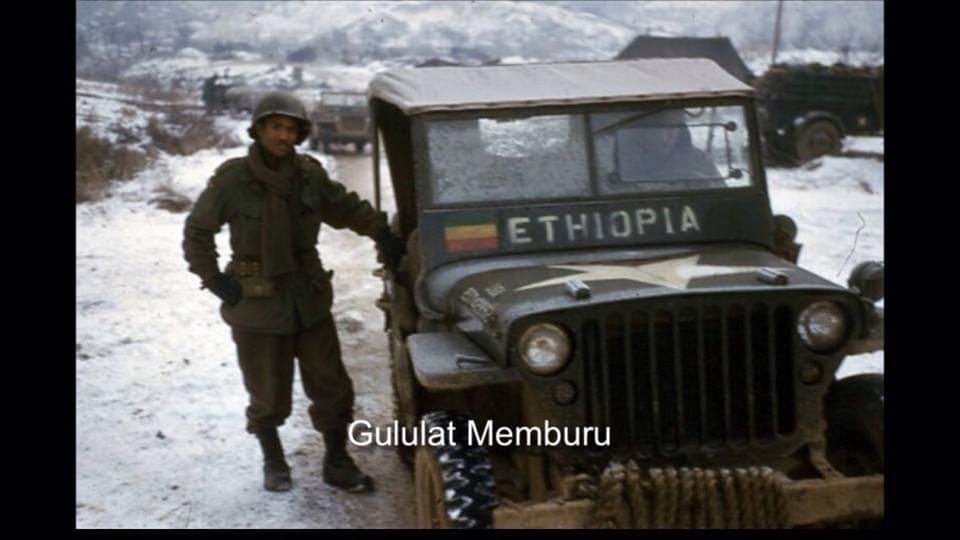 A photo of Colonel Gulelat standing next to a military jeep in Korea.